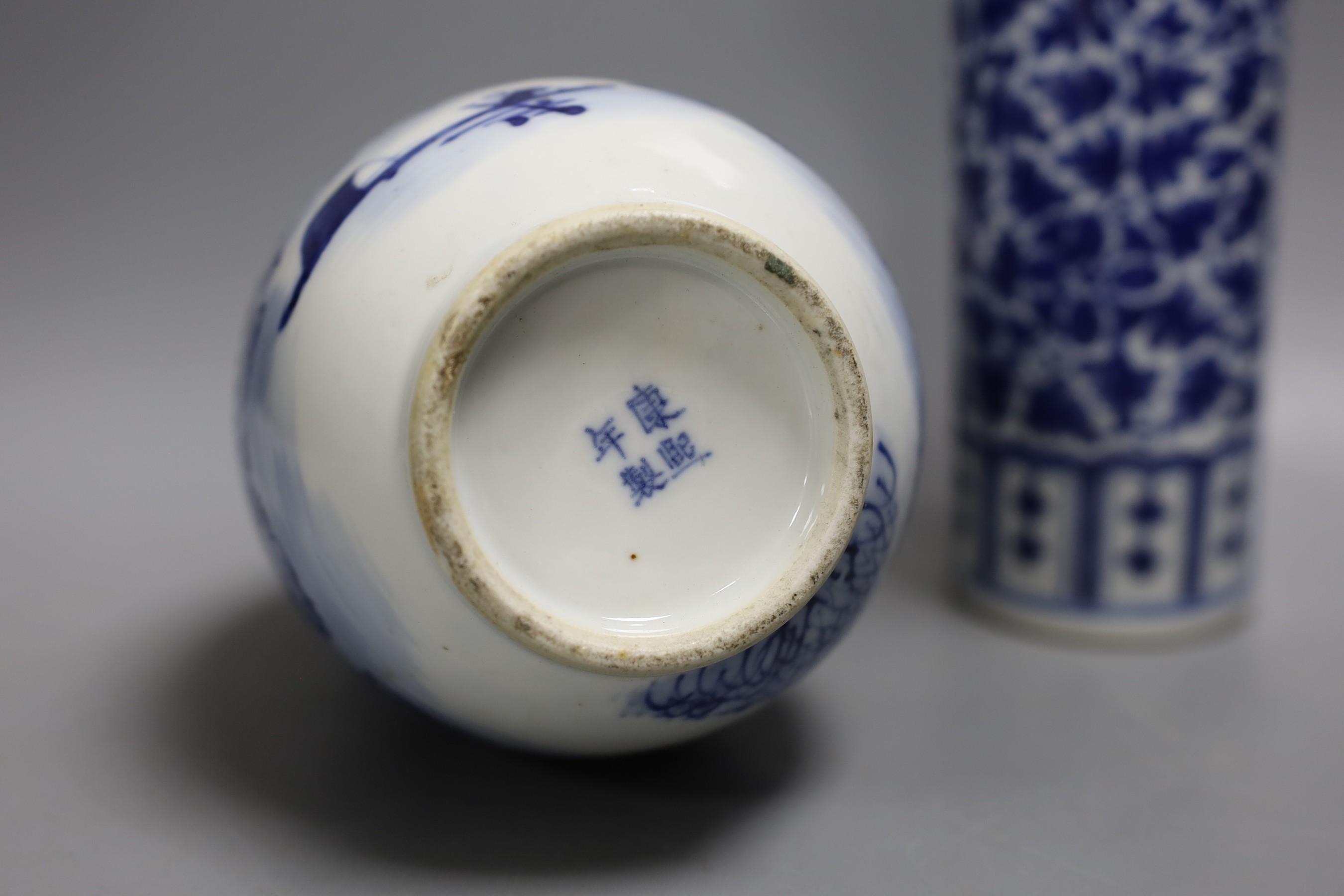 A 19th century Chinese blue and white ‘landscape’ vase, an early 20th century blue and white sleeve vase and three blue and white jars and covers. Tallest 25.5cm